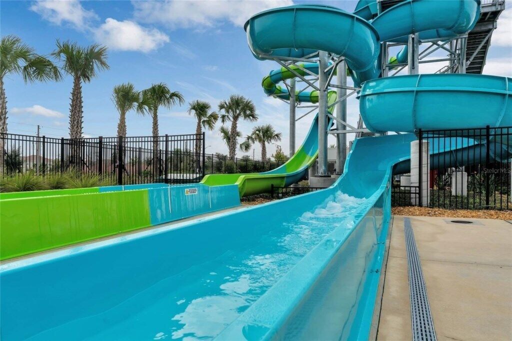 A water park with multiple water slides and a fenced area.