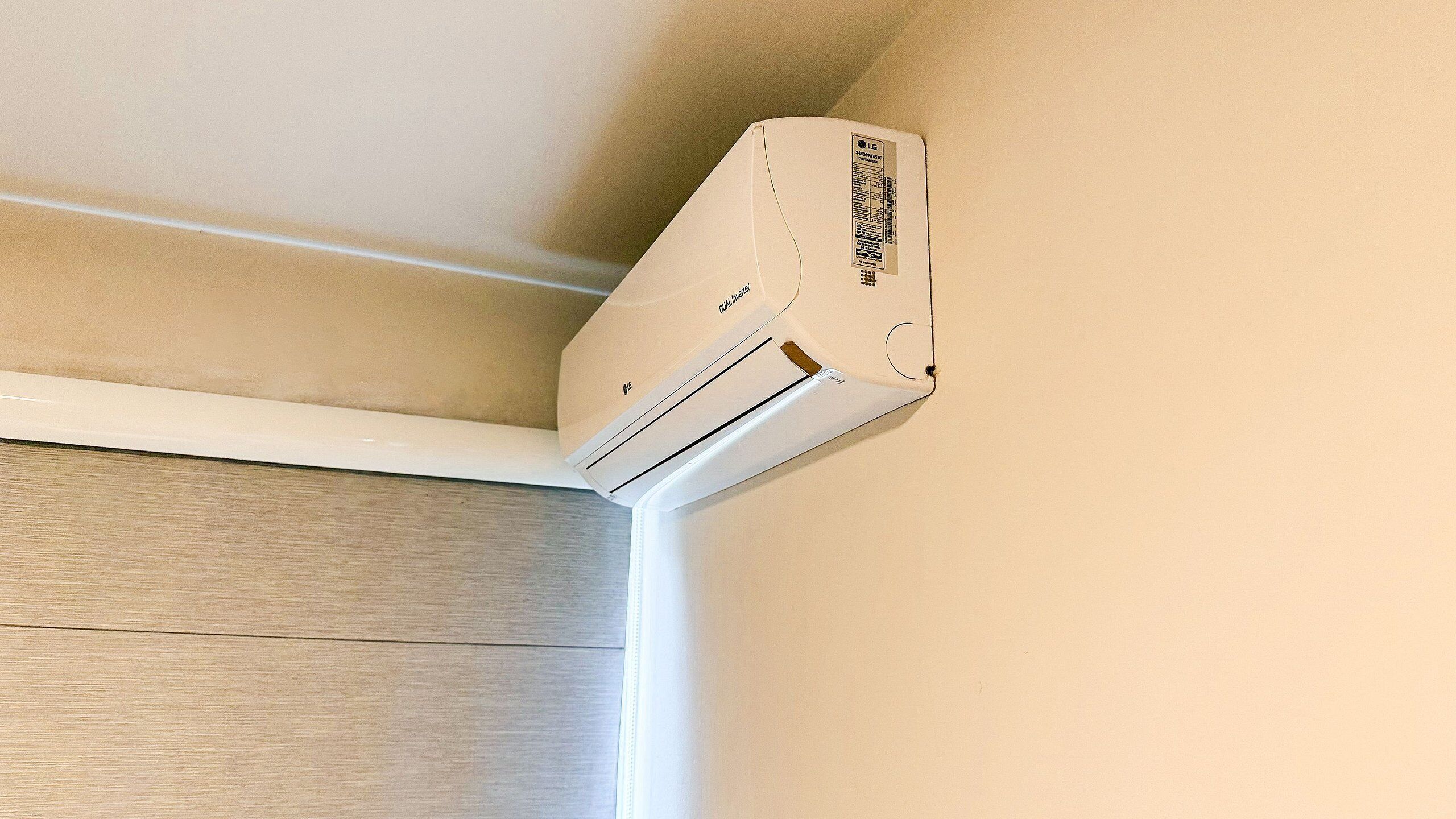 Un appareil de climatisation fixé au mur, dans un coin.