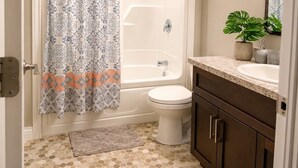 A bathroom with a shower, toilet, and sink. - Cozy 1BR Suite in Kenmount Terrace. (St. John's)