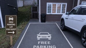 A parking lot with a sign indicating free parking for guests.