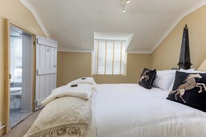 Een slaapkamer met een bed, een raam en een deur.