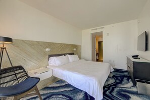 A hotel room with a bed, a desk, a chair, a lamp, and a TV. - Cozy 2-bedroom Condo At W Residences Fort Lauderdale With Pool & Beach Service (Fort Lauderdale)