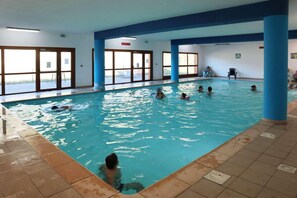 An indoor swimming pool with multiple lanes, blue pillars, and large windows. - Ski-in/ski-out & foot of the slopes, 1st floor, balcony, tv, 50m², Les Orres (Les Orres)