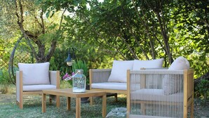 A wooden outdoor seating area with two sofas and a table, surrounded by greenery. - Shabby chic cottage with pool in Chianti (Castellina in Chianti)