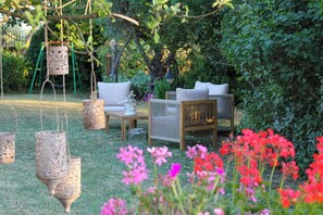An outdoor seating area with wicker furniture and hanging lanterns. - Shabby chic cottage with pool in Chianti (Castellina in Chianti)