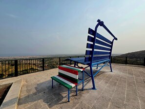 A bench with a view of a cityscape.