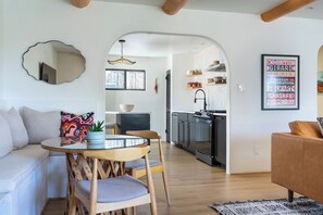 A modern living space with a dining area, kitchen, and a cozy seating area. - Resort-Style City Oasis with Heated Private Pool & Hot Tub (Santa Fe)