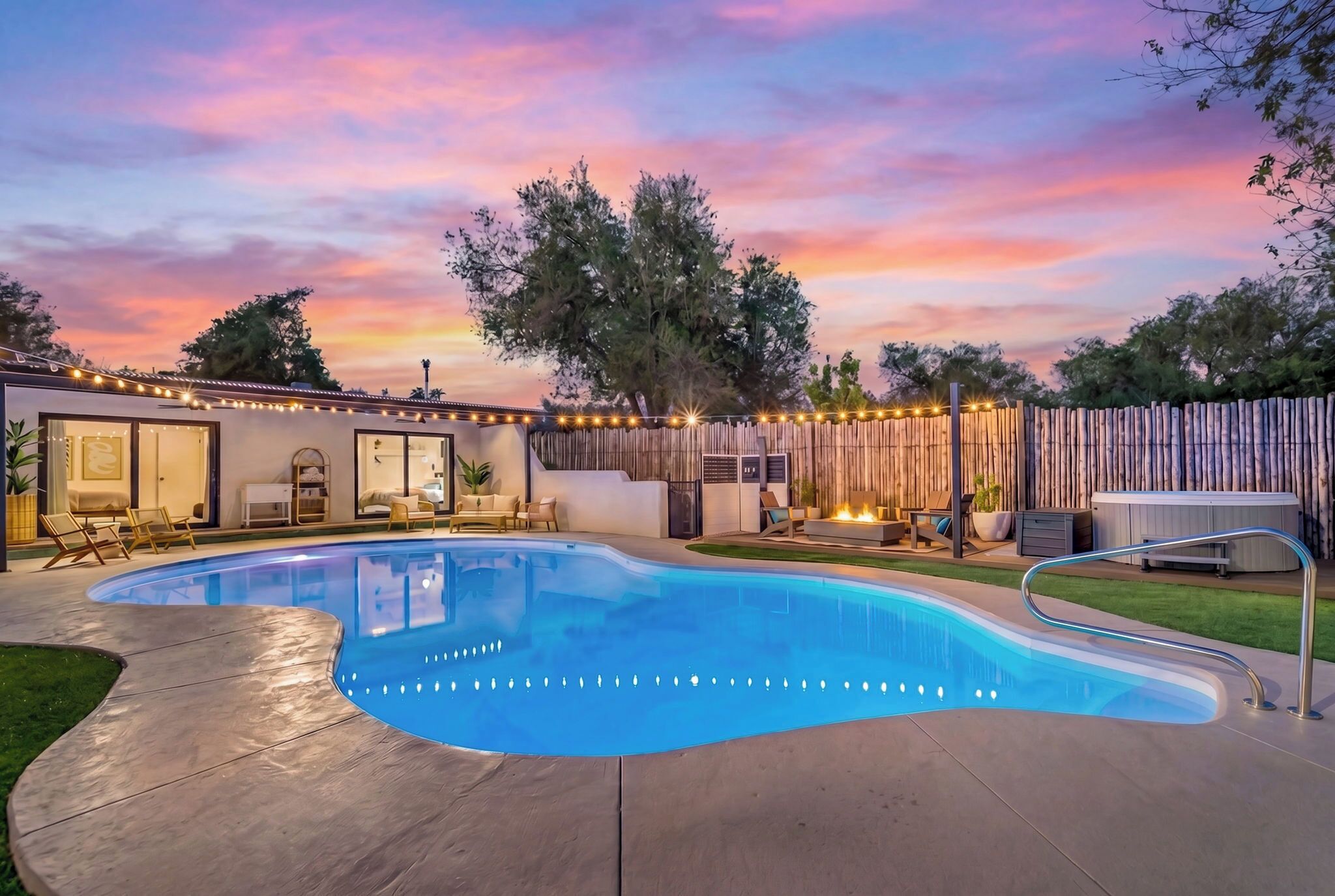 A backyard with a swimming pool, outdoor seating, and a fire pit.