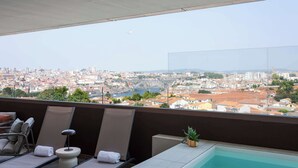 A balcony with a pool, lounge chairs, and a view of a cityscape. - Private Heated Pool & Dom Luis Views by HostWise (Vila Nova de Gaia)
