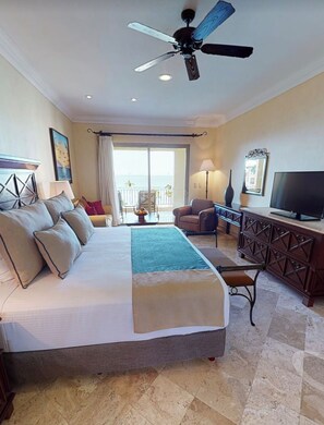 A hotel room with a large bed, a ceiling fan, a television, and a view of the outdoors. - Luxury One-Bedroom Suite at Villa La Estancia Beach Resort & Spa Riviera Nayarit (Puerto Vallarta)