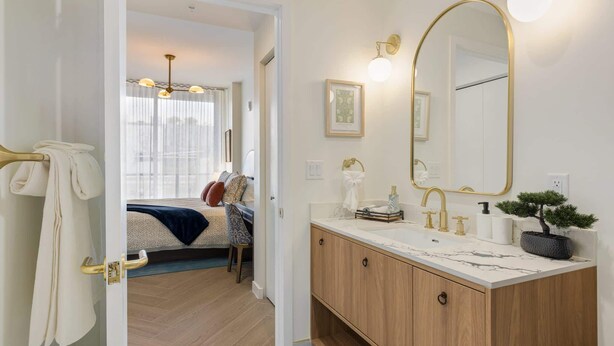 A modern bathroom with a large mirror, dual sinks, and a potted plant. - 1BR 1BA Miami Apt Pool Ocean Views Ideal for 3 (Miami)