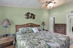 A bedroom with a bed, two nightstands, a ceiling fan, and a dresser. - Exec Bay Resort-Style 4BR Townhome w/Beach, Marina, Heat/Chill Pool & Pickleball (Islamorada)