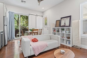 A modern living room with a sofa, a coffee table, and a bookshelf.
