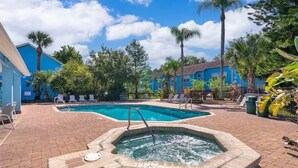 A swimming pool area with lounge chairs and a hot tub. - Lyrios Vacation Rentals - The Villas (Kissimmee)