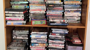 A bookshelf filled with various video game cases.