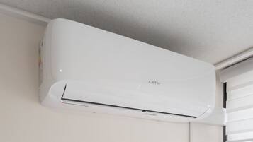 A white wall-mounted air conditioner with the brand name 'ARTIK' visible.
