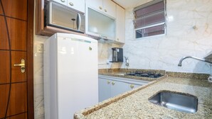 A kitchen with a refrigerator, stove, sink, and cabinets. - 2-bedroom Apt 150m From the Beach Tib0103 (Guarapari)