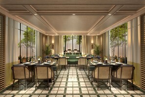 A dining area with a checkered floor, long tables, wicker chairs, and a view through large windows. - Park Hyatt Phu Quoc (Phu Quoc)