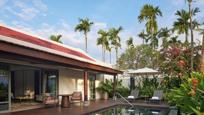A modern house with a swimming pool, outdoor seating, and tropical plants. - Park Hyatt Phu Quoc (Phu Quoc)
