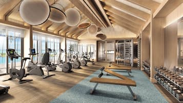 A modern gym with various exercise equipment, large windows, and a wooden interior.