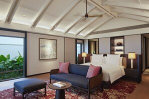 A hotel room with a bed, a sofa, a small table, and a large window. - Park Hyatt Phu Quoc (Phu Quoc)