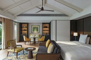 A hotel room with a bed, a sofa, a dining table with chairs, a ceiling fan, and a view of the outdoors. - Park Hyatt Phu Quoc (Phu Quoc)