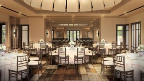 A spacious banquet hall with multiple round tables, chairs, and a high ceiling with a central light fixture. - Park Hyatt Phu Quoc (Phu Quoc)