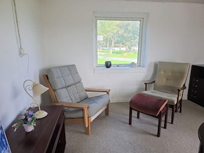 A room with a window, two chairs, a small table, and a lamp. - 2 Person Holiday Home in Vra (Vra)