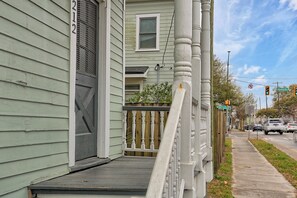 A two-story house with a front porch and a garage door. - Savannah Home, Walkable to Forsyth, Historic (Savannah)