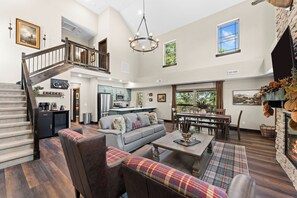A spacious living area with a staircase, a dining table, and a fireplace. - 4 Ensuite Baths | Hot Tub | Pool + Lazy River (Hollister)