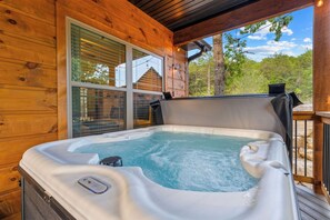 A hot tub on a wooden deck with a view of trees and a clear sky. - Oak-Zarks Getaway - Cabin w/ 2 King Suites, Hot Tub, Fire Pit + Resort Amenities (Hollister)