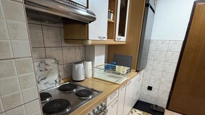A kitchen with a stove, oven, and cabinets.