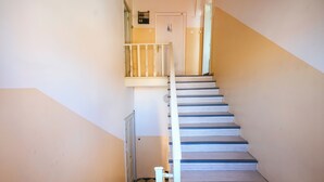 A staircase with white balusters and a checkered floor. - Ema Studio on the Main Promenade (Koper)