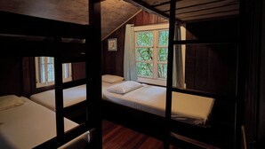 A bunk bed room with wooden walls and a window with curtains. - Family & Pet friendly•Nestled in the forest•Trails•Waterfalls 13 km away•8 beds• (Luisa)