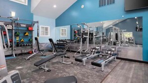 A gym with various exercise equipment, including treadmills, weight machines, and free weights. - Mins 2: VA, UF SanteFe U, UF Shands, HCA ,Airport (Gainesville)