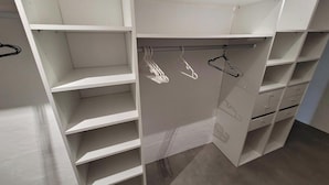 Un armario vestidor con amplios estantes y espacio para colgar.