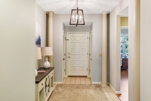 A hallway with a white door, a lamp, and a rug. - Tall Ship 337 Keowee Key (Salem)
