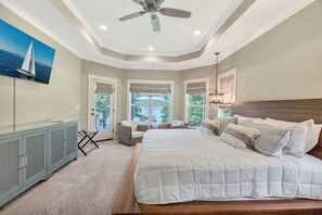 A bedroom with a large bed, a ceiling fan, and a view of the outdoors. - McAlister Rd Simply Spectacular (West Union)