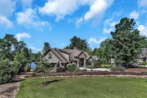 A two-story house with a stone facade, a front porch, and a well-maintained lawn. - McAlister Rd Simply Spectacular (West Union)