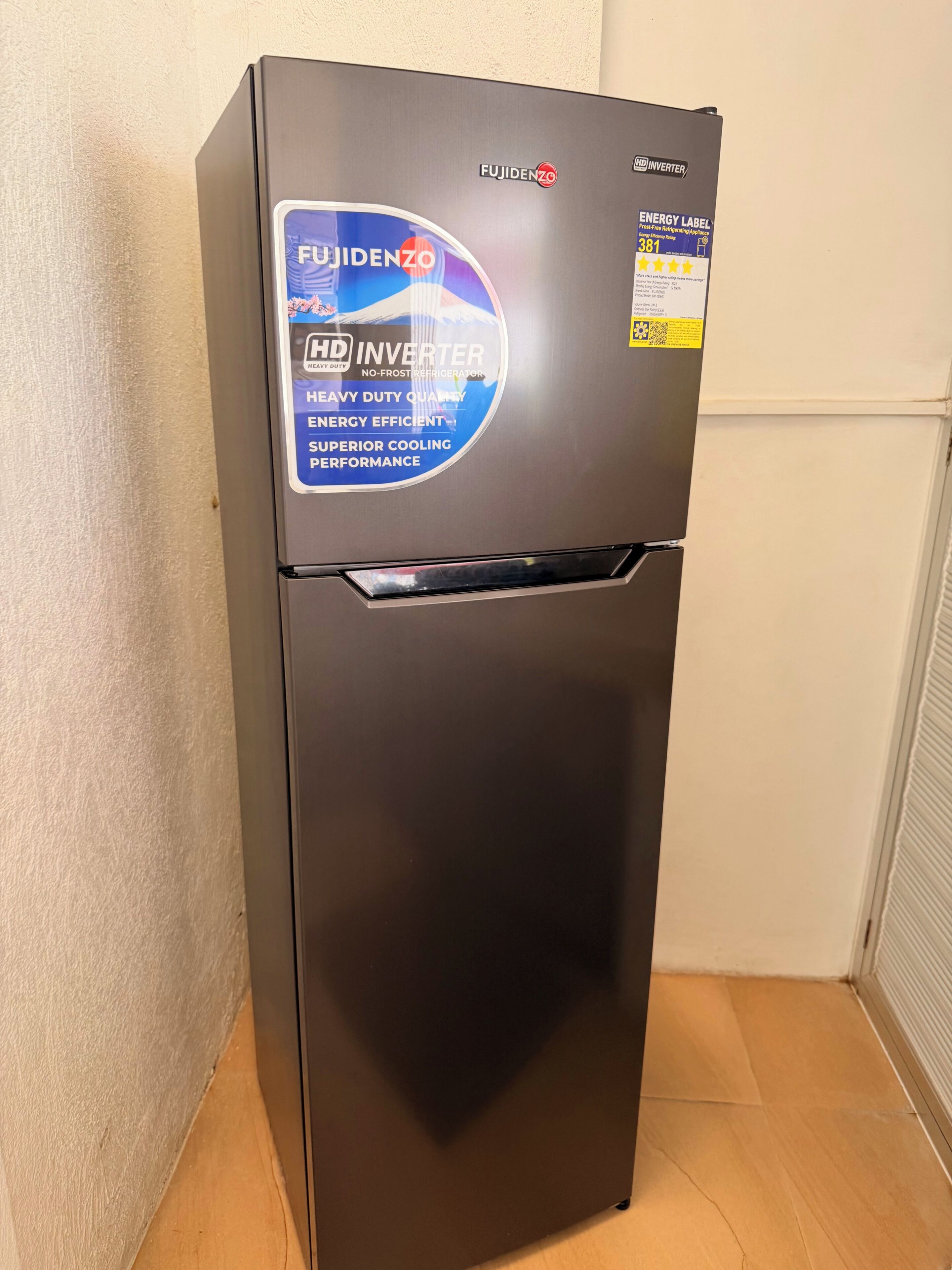 A black Fujidenzo HD Inverter refrigerator with a blue energy efficiency label.
