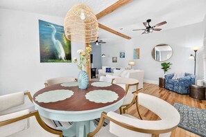 A dining area with a round table, chairs, and a hanging light fixture. - 2BR/2BA Lincolnville Home | Yard & Fire Pit (St. Augustine)