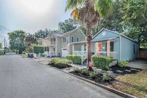 A residential street with houses featuring front porches and a palm tree. - 2BR/2BA Lincolnville Home | Yard & Fire Pit (St. Augustine)