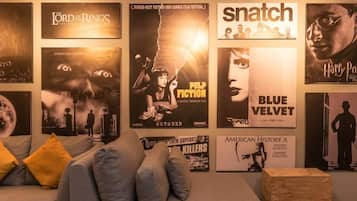 A wall with movie posters including 'The Lord of the Rings', 'Snatch', and 'Blue Velvet'.
