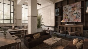 A modern lounge area with seating arrangements, a coffee table, and a wall-mounted speaker.