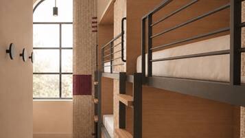 A room with bunk beds, a window with curtains, and a hanging light fixture.