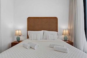 A hotel room with a large bed, two bedside lamps, and a window with curtains. - Escape to Coastal Comfort | Villa 1030 (Famagusta)