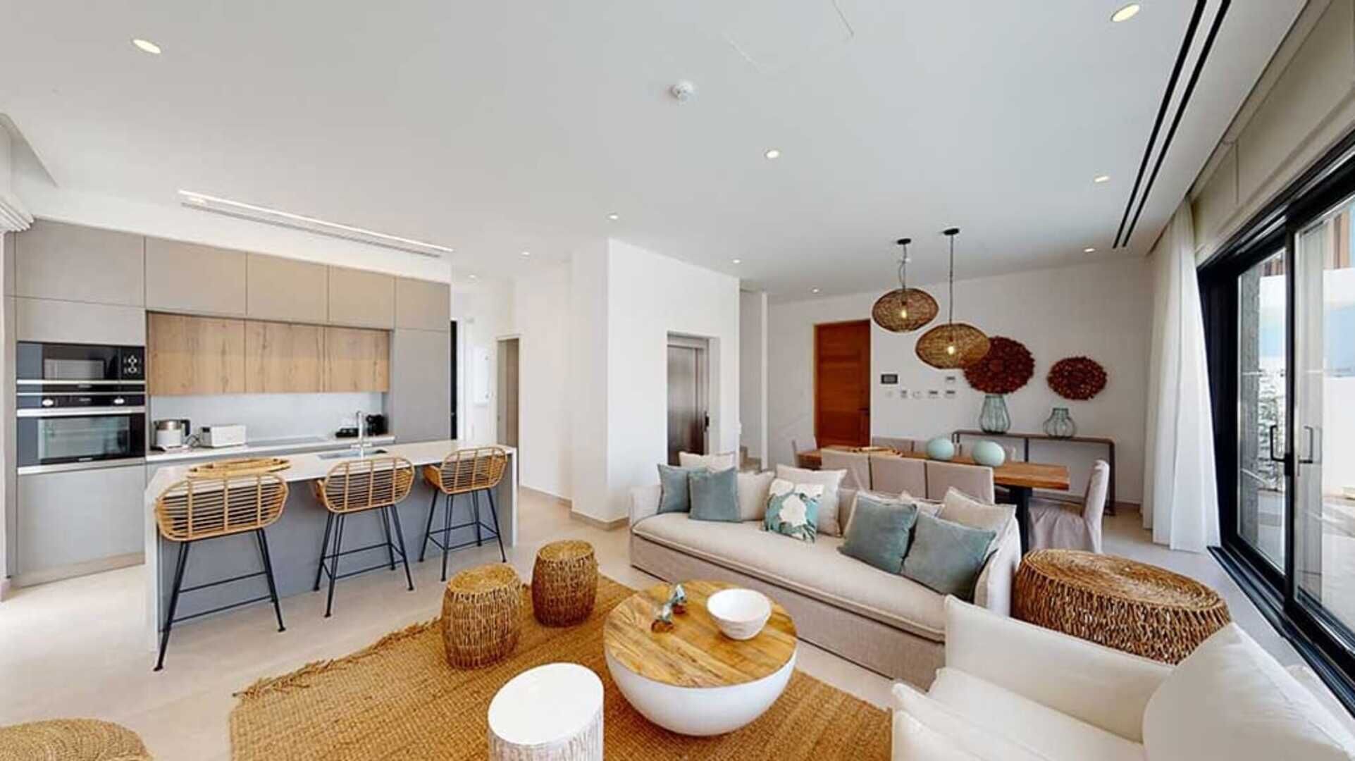 A modern living space with a kitchen, dining area, and seating area.