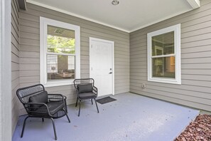 A covered porch with two chairs and a door. - 7 Minutes to Campus! (Gainesville)