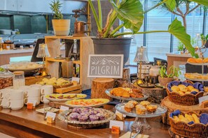 A buffet setup with various food items and a sign labeled 'PILGRIM.' - Hotel101 - Davao (Davao)