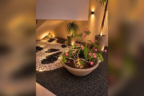 A potted plant with pink flowers and a small tree in a well-lit indoor setting. - Penthouse in Cabarete. Pool, Gym & Beach (Cabarete)